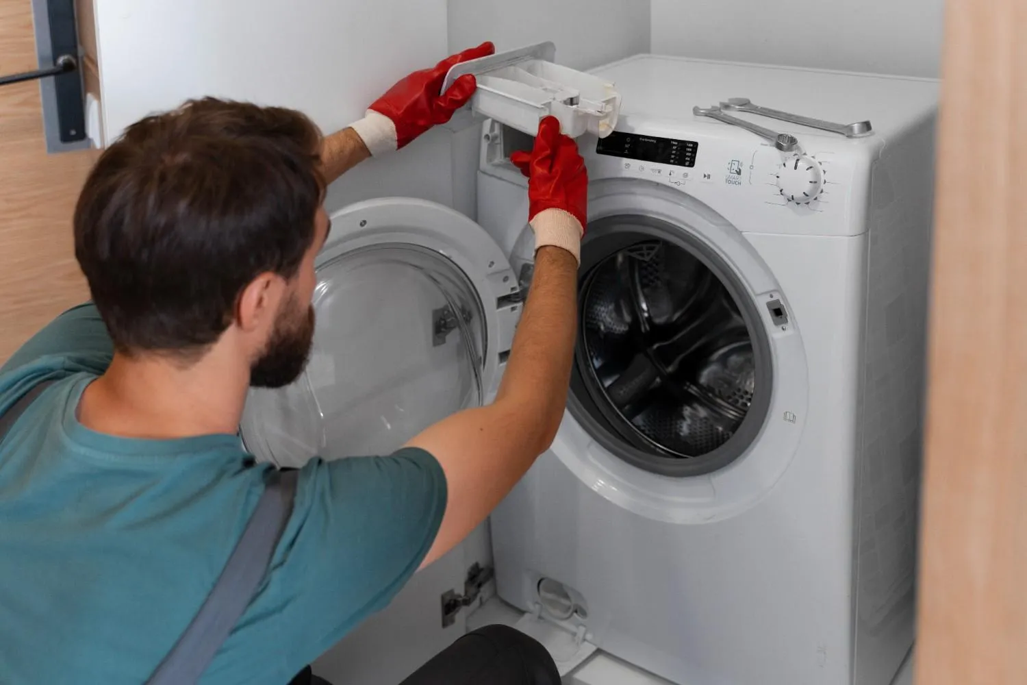 Technician repairing a front-load washing machine